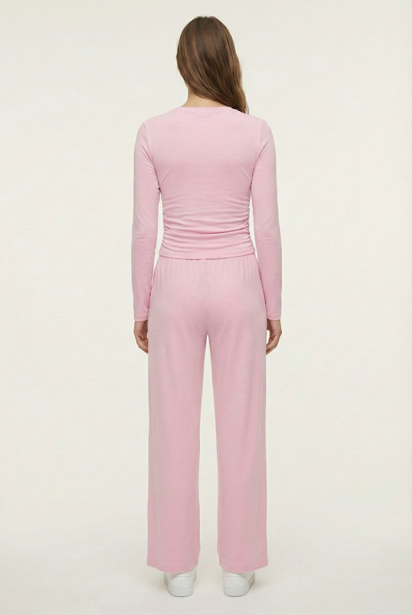 Model wearing The Rive Set sleek stretch lounge set in Rosewater by Lohnr, featuring a ruched long-sleeve top and wide-leg drawstring pants