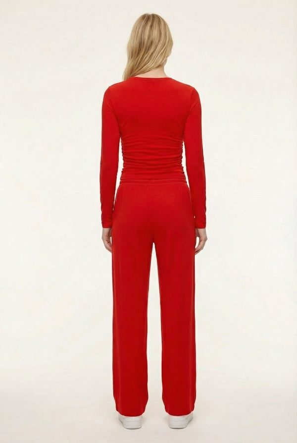 Model wearing The Rive Set sleek stretch lounge set in Rouge by Lohnr, featuring a ruched long-sleeve top and wide-leg drawstring pants