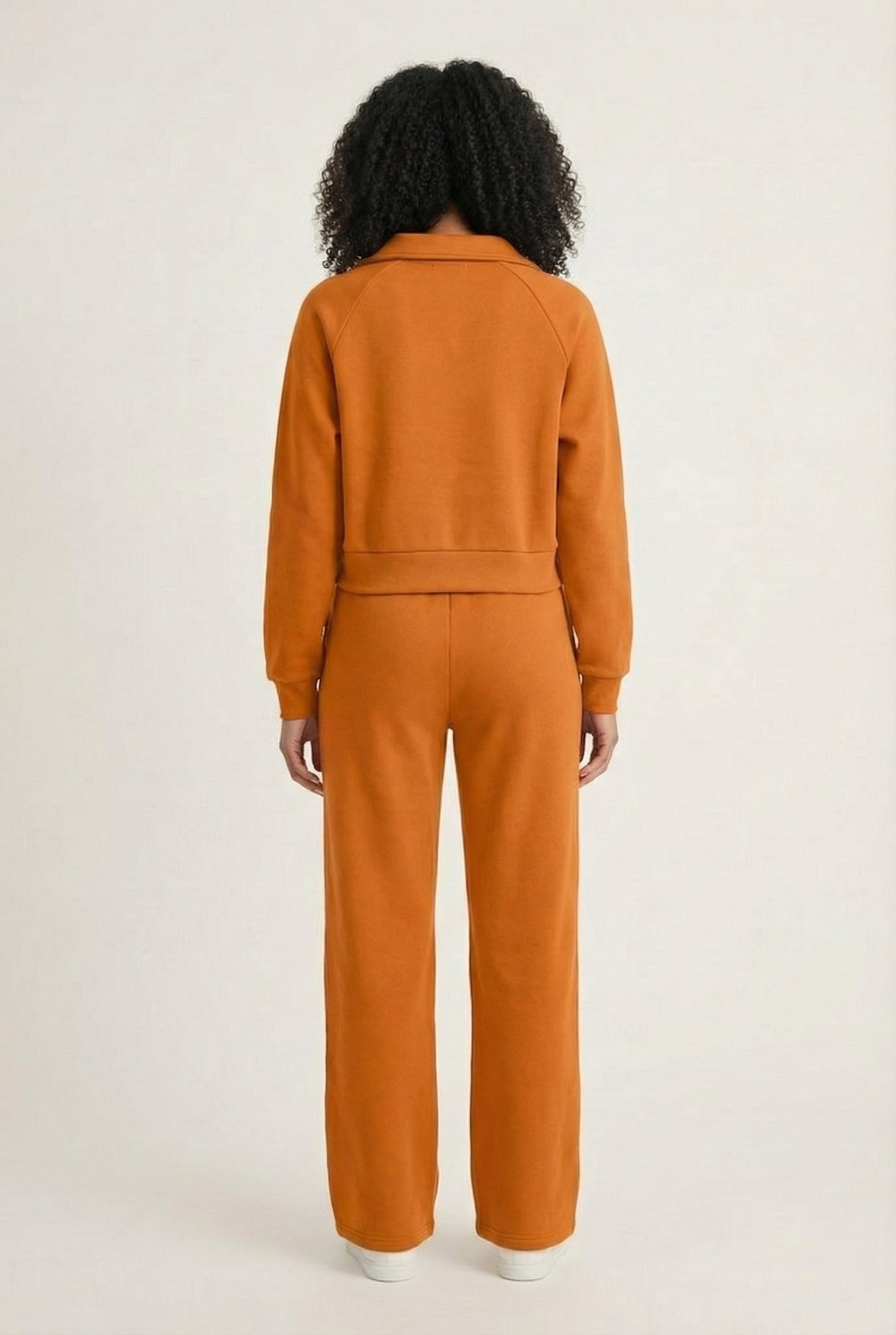 Model wearing the LOHNR Ventura Set in Ember, a premium soft scuba matching set featuring a sculpted V-neck and wide-leg pants for refined comfort.