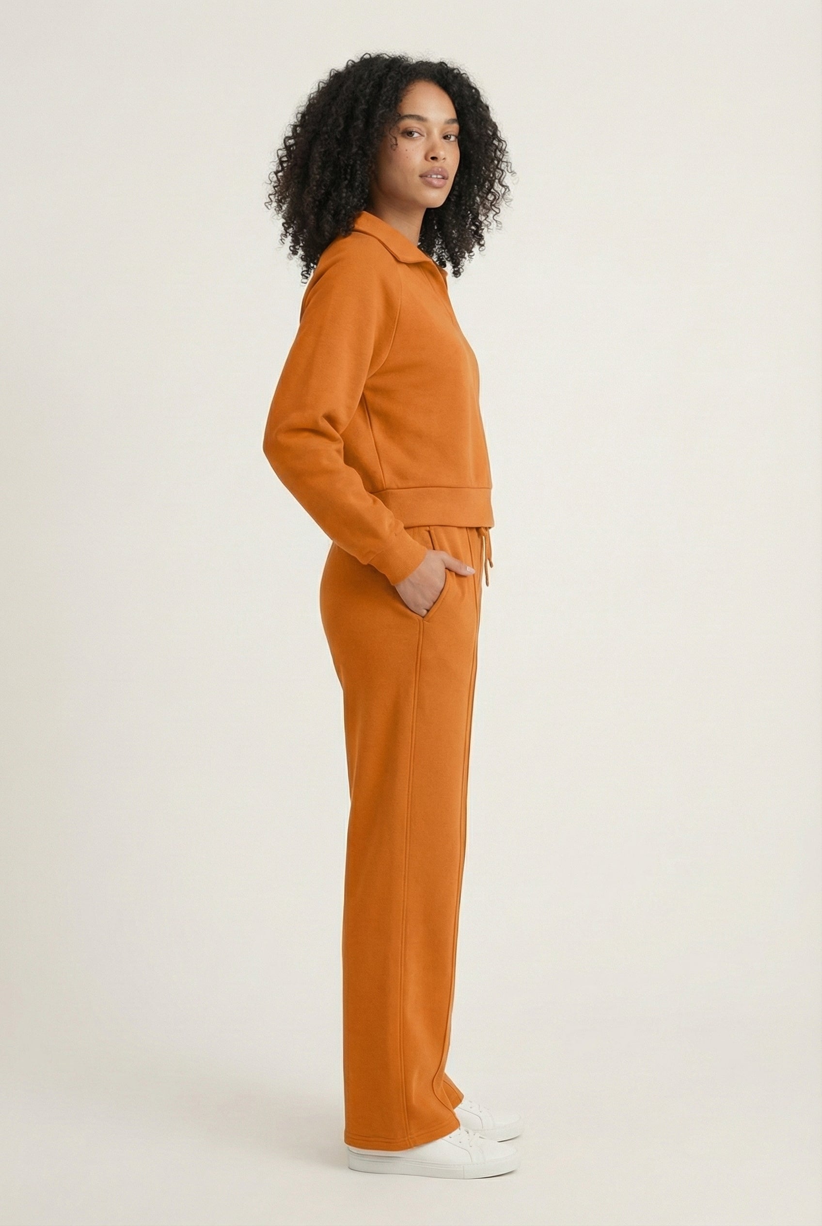 Model wearing the LOHNR Ventura Set in Ember, a premium soft scuba matching set featuring a sculpted V-neck and wide-leg pants for refined comfort.