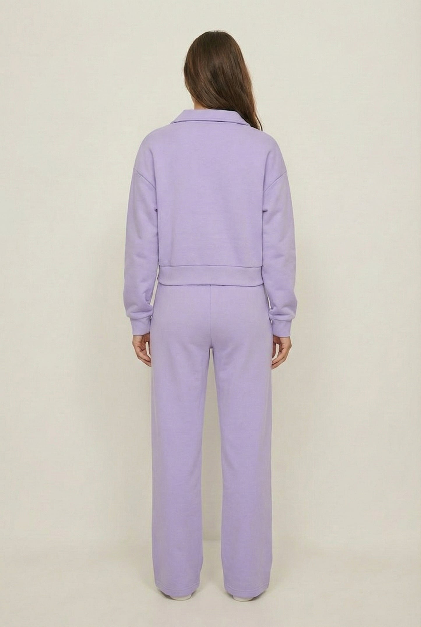 Model wearing the LOHNR Ventura Set in Lilac, a premium soft scuba matching set featuring a sculpted V-neck and wide-leg pants for refined comfort.