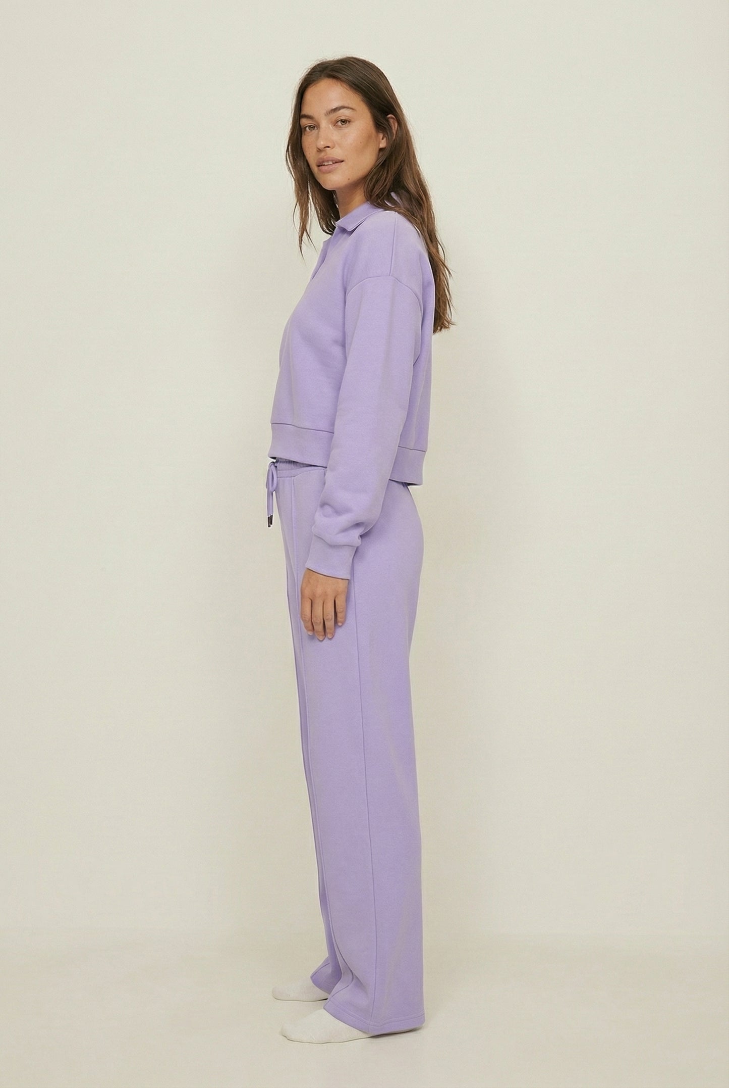 Model wearing the LOHNR Ventura Set in Lilac, a premium soft scuba matching set featuring a sculpted V-neck and wide-leg pants for refined comfort.