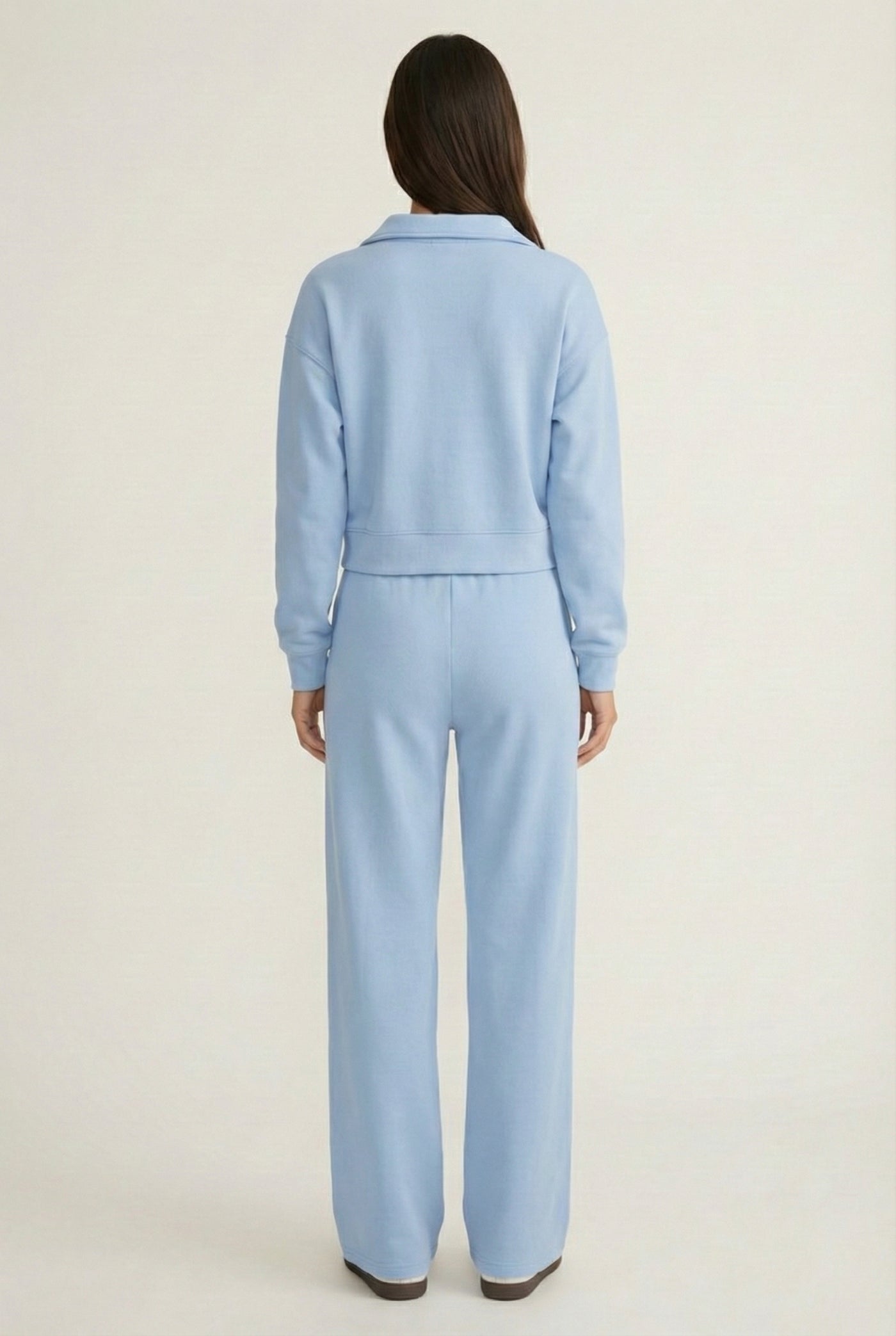 Model wearing the LOHNR Ventura Set in Sky, a premium soft scuba matching set featuring a sculpted V-neck and wide-leg pants for refined comfort.