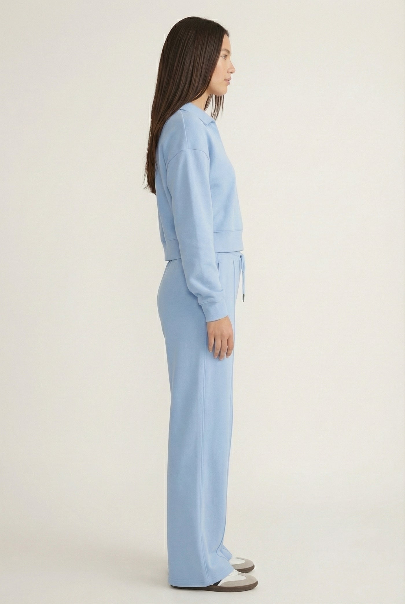 Model wearing the LOHNR Ventura Set in Sky, a premium soft scuba matching set featuring a sculpted V-neck and wide-leg pants for refined comfort.
