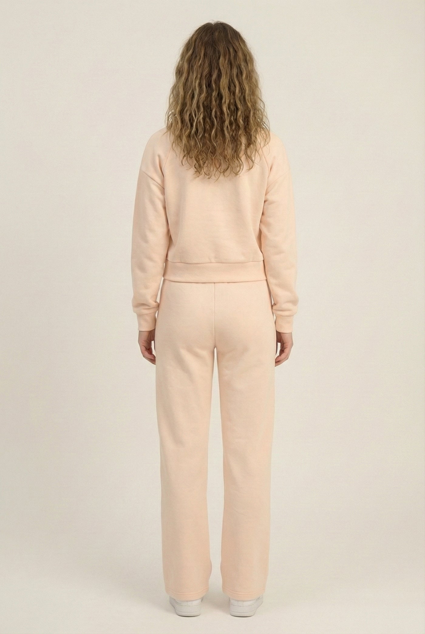 Model wearing the LOHNR Ventura Set in Soft Apricot, a premium soft scuba matching set featuring a sculpted V-neck and wide-leg pants for refined comfort.