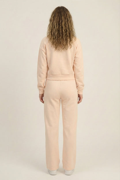 Model wearing the LOHNR Ventura Set in Soft Apricot, a premium soft scuba matching set featuring a sculpted V-neck and wide-leg pants for refined comfort.