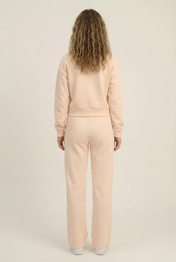 Model wearing the LOHNR Ventura Set in Soft Apricot, a premium soft scuba matching set featuring a sculpted V-neck and wide-leg pants for refined comfort.