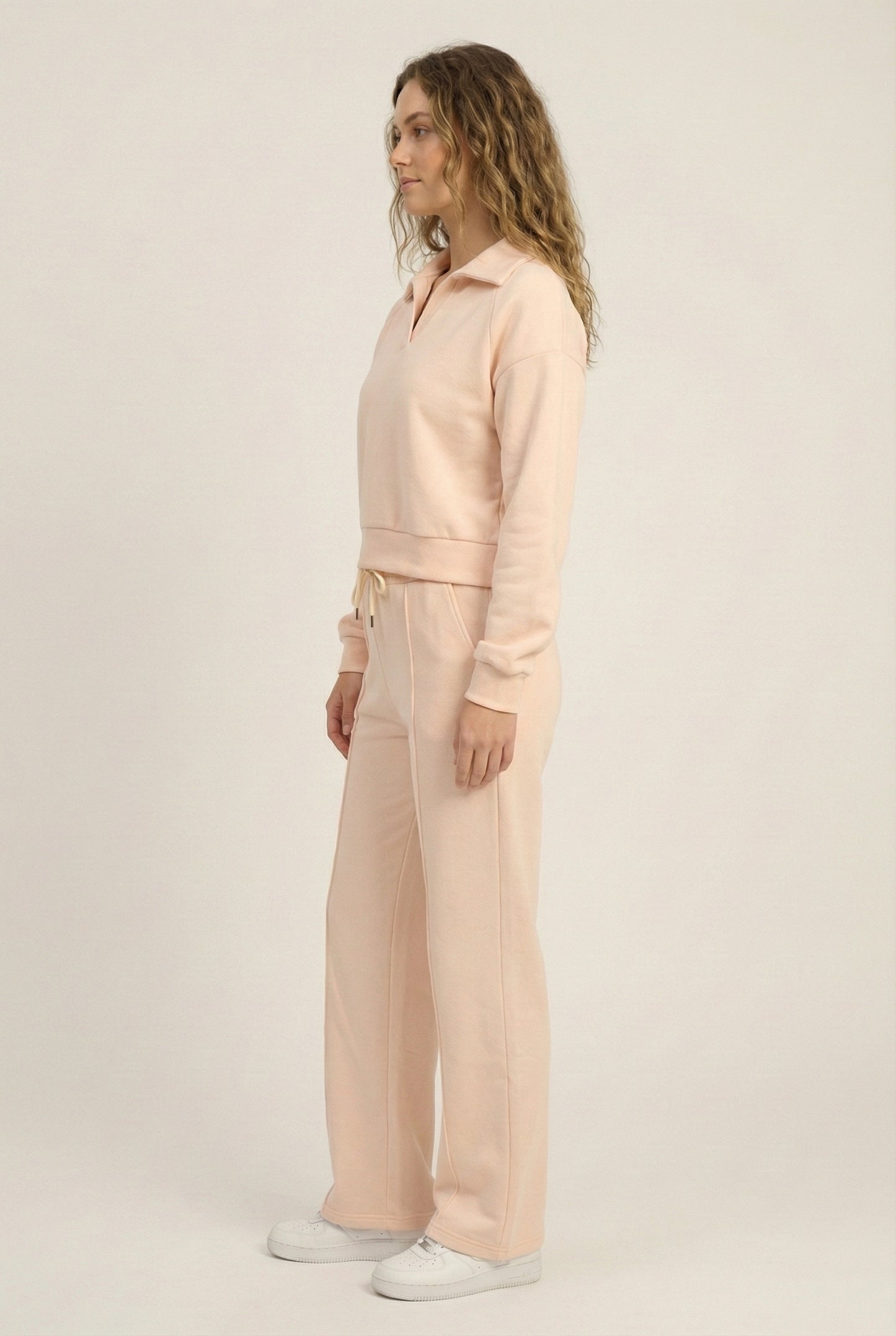 Model wearing the LOHNR Ventura Set in Soft Apricot, a premium soft scuba matching set featuring a sculpted V-neck and wide-leg pants for refined comfort.