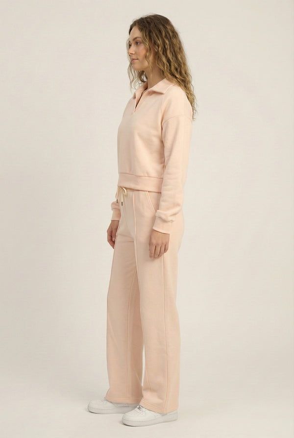 Model wearing the LOHNR Ventura Set in Soft Apricot, a premium soft scuba matching set featuring a sculpted V-neck and wide-leg pants for refined comfort.