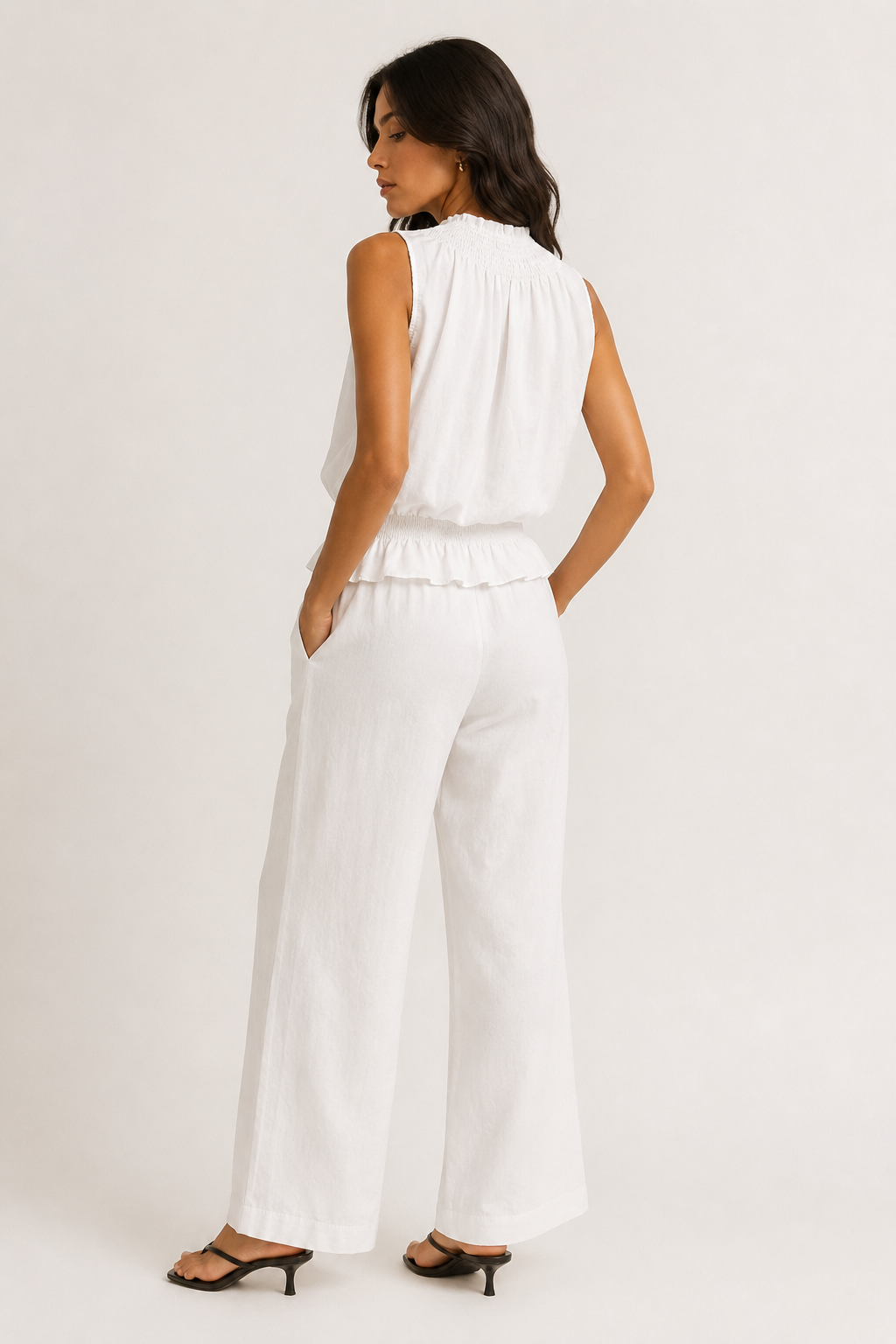 Woman wearing a premium minimalist washed onyx black two piece set with sleeveless top and wide leg pants