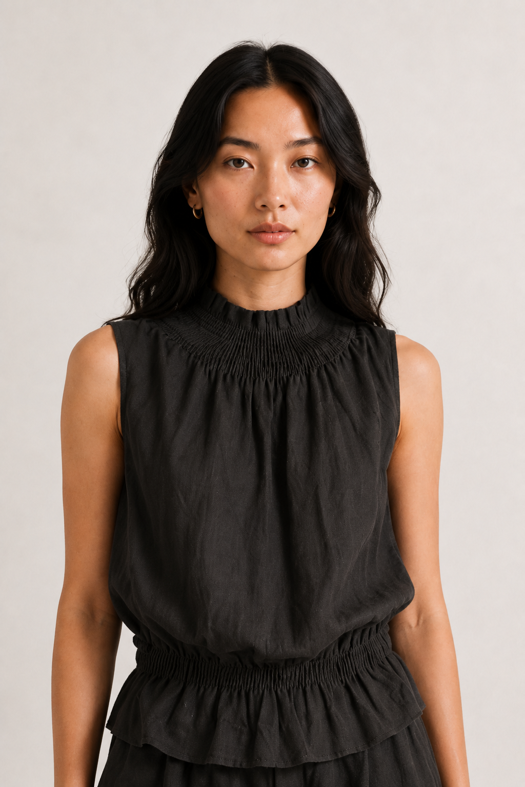 Woman wearing a premium minimalist washed onyx black two piece set with sleeveless top and wide leg pants