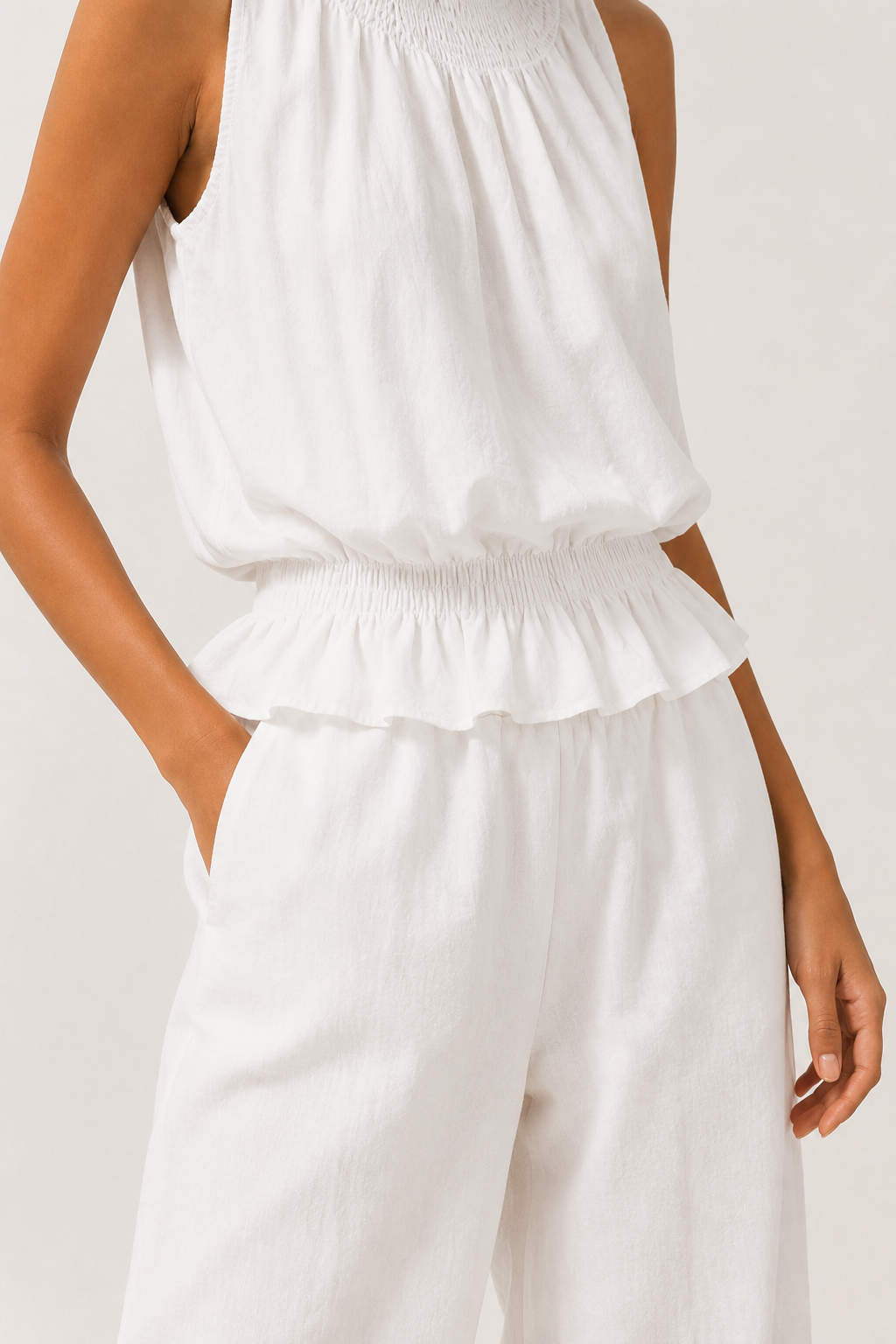 Woman wearing a premium minimalist washed onyx black two piece set with sleeveless top and wide leg pants