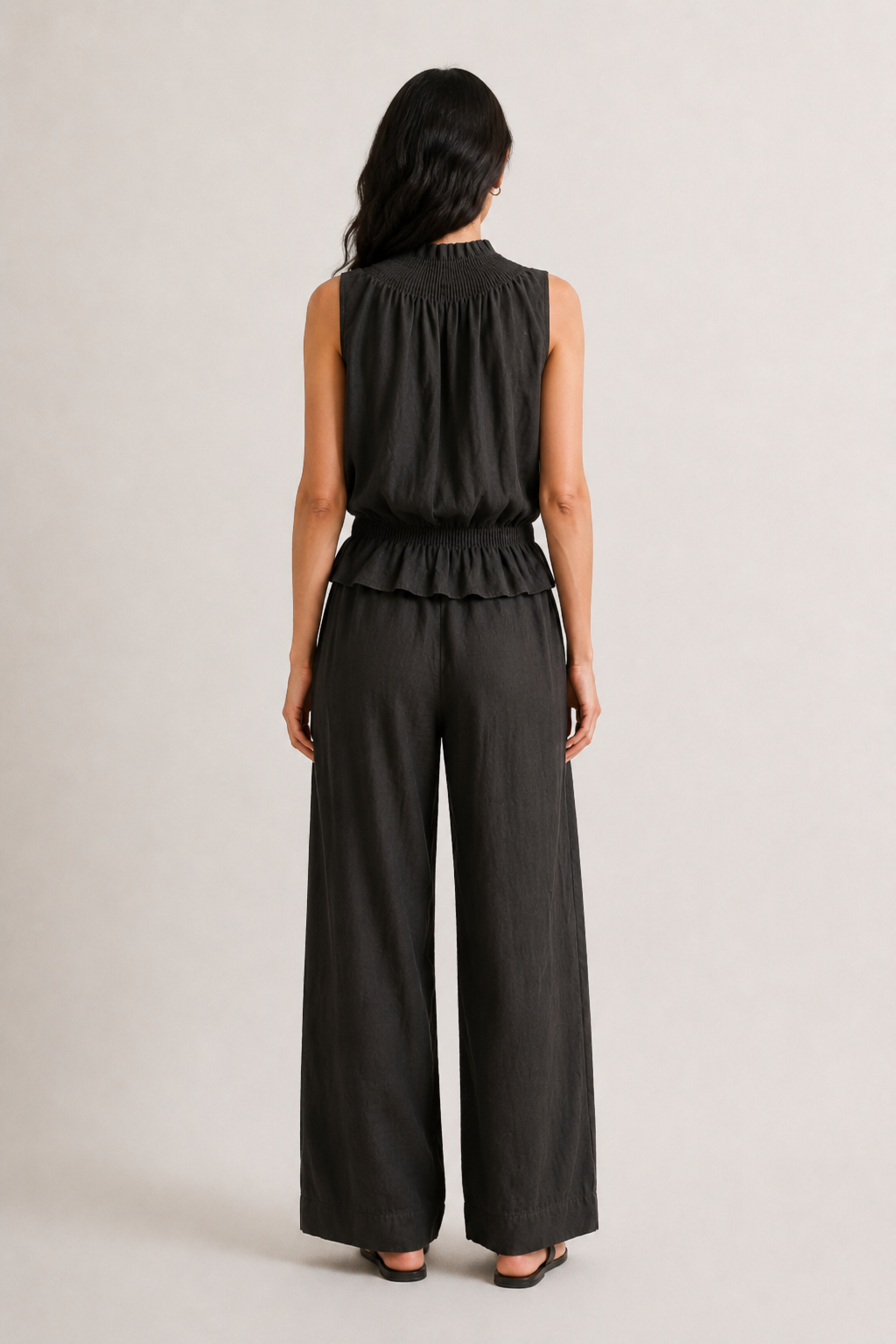 Woman wearing a premium minimalist washed onyx black two piece set with sleeveless top and wide leg pants