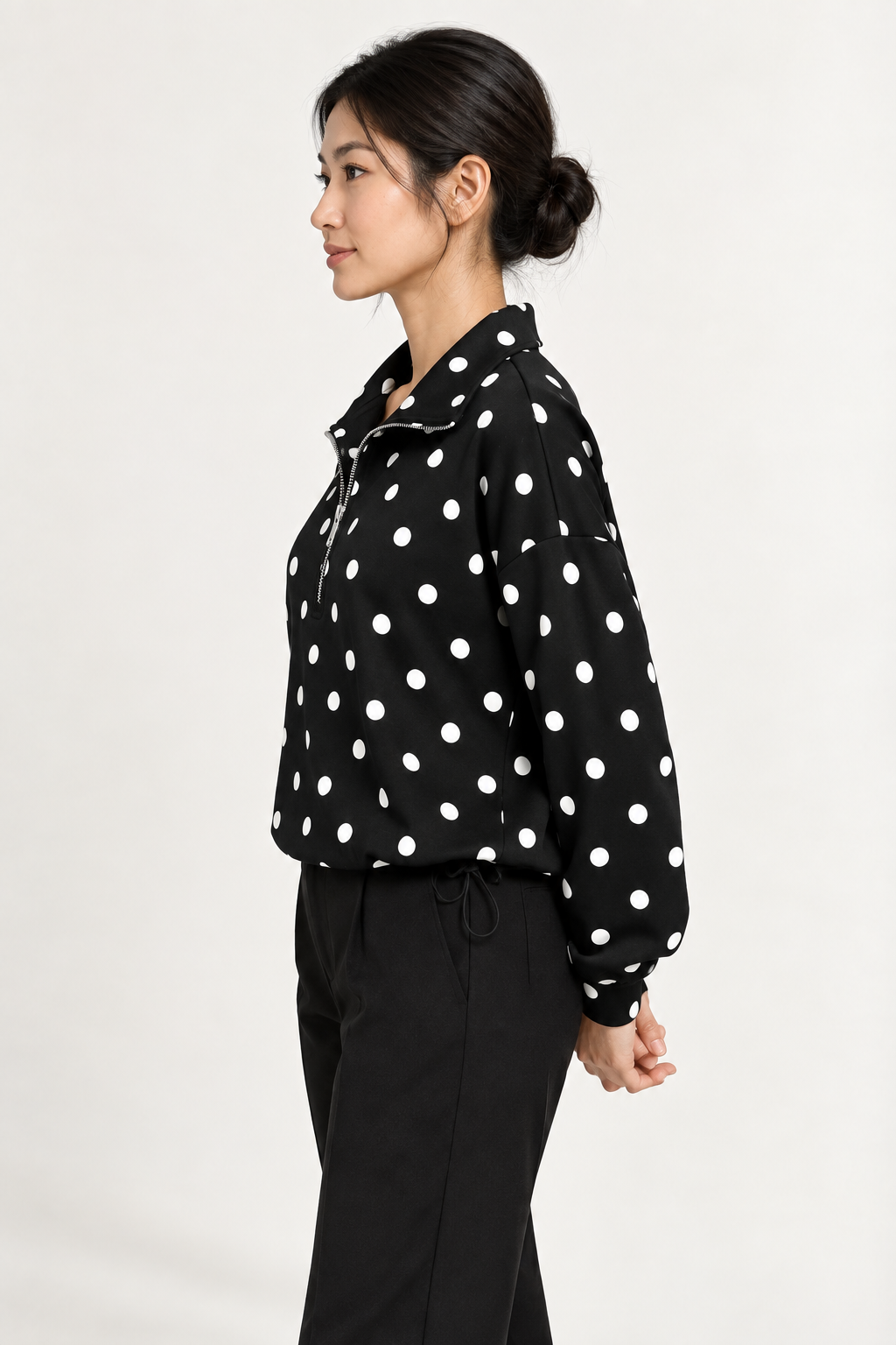 Pippa Polka-Dot Half-Zip in Black, side hands back view on an adult model.
