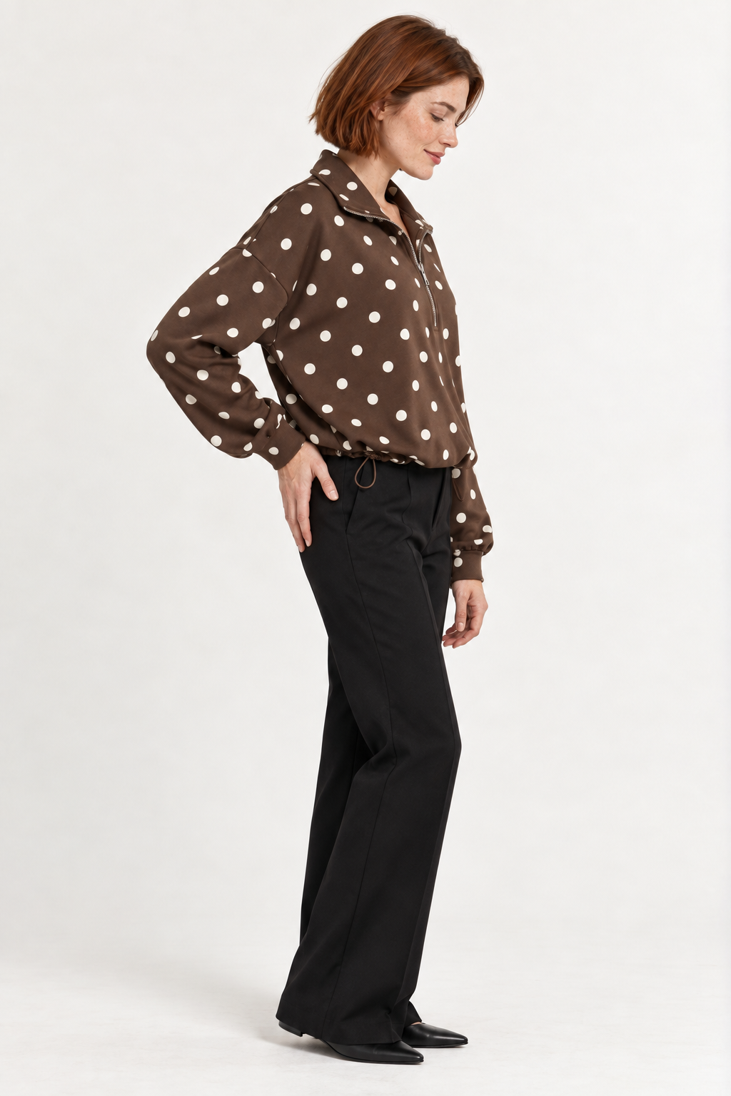 Pippa Polka-Dot Half-Zip in Brown, side hand hip view on an adult model.