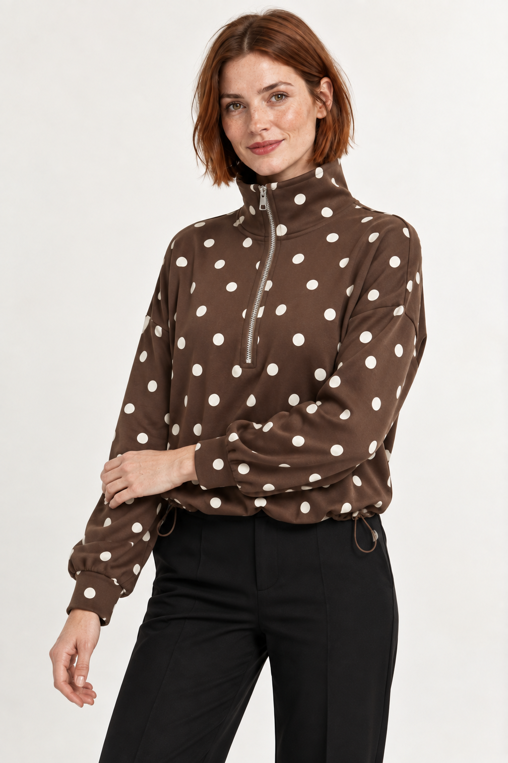 Pippa Polka-Dot Half-Zip in Brown, raised zip sleeve view on an adult model.