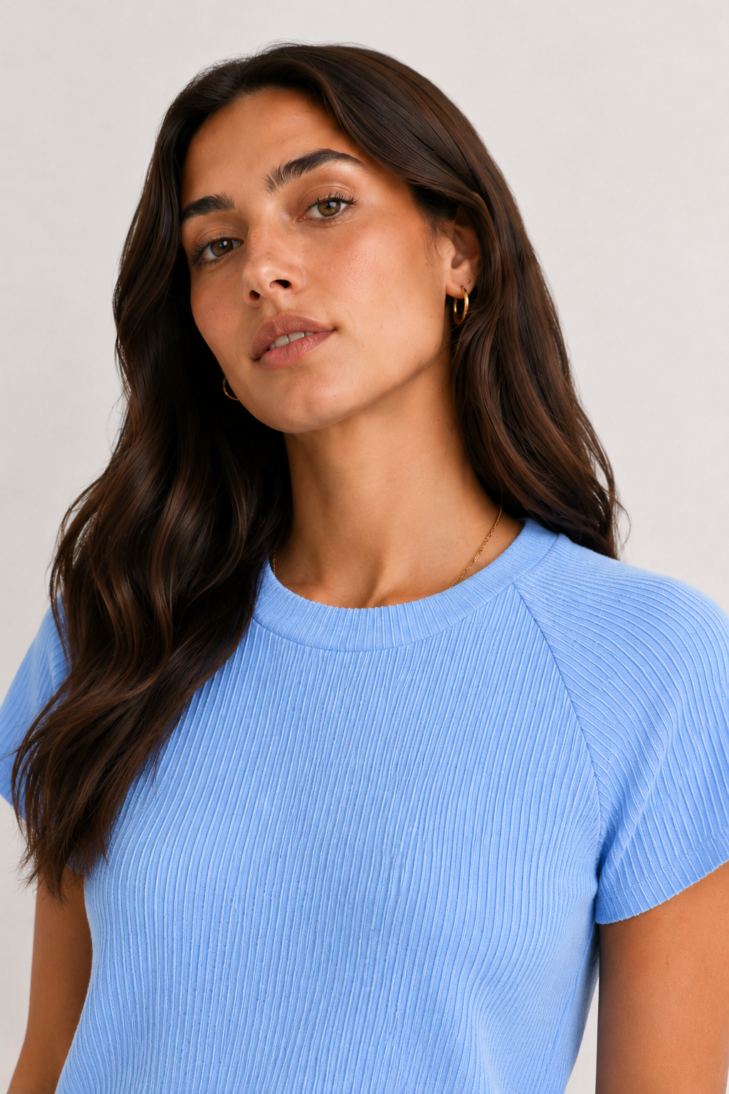 Woman wearing a powder blue short sleeve top and matching mini skirt lounge set.