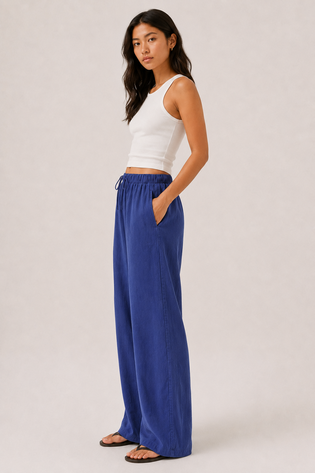 Woman modeling premium high-waisted wide-leg pants in bright blue Cobalt against a clean studio background