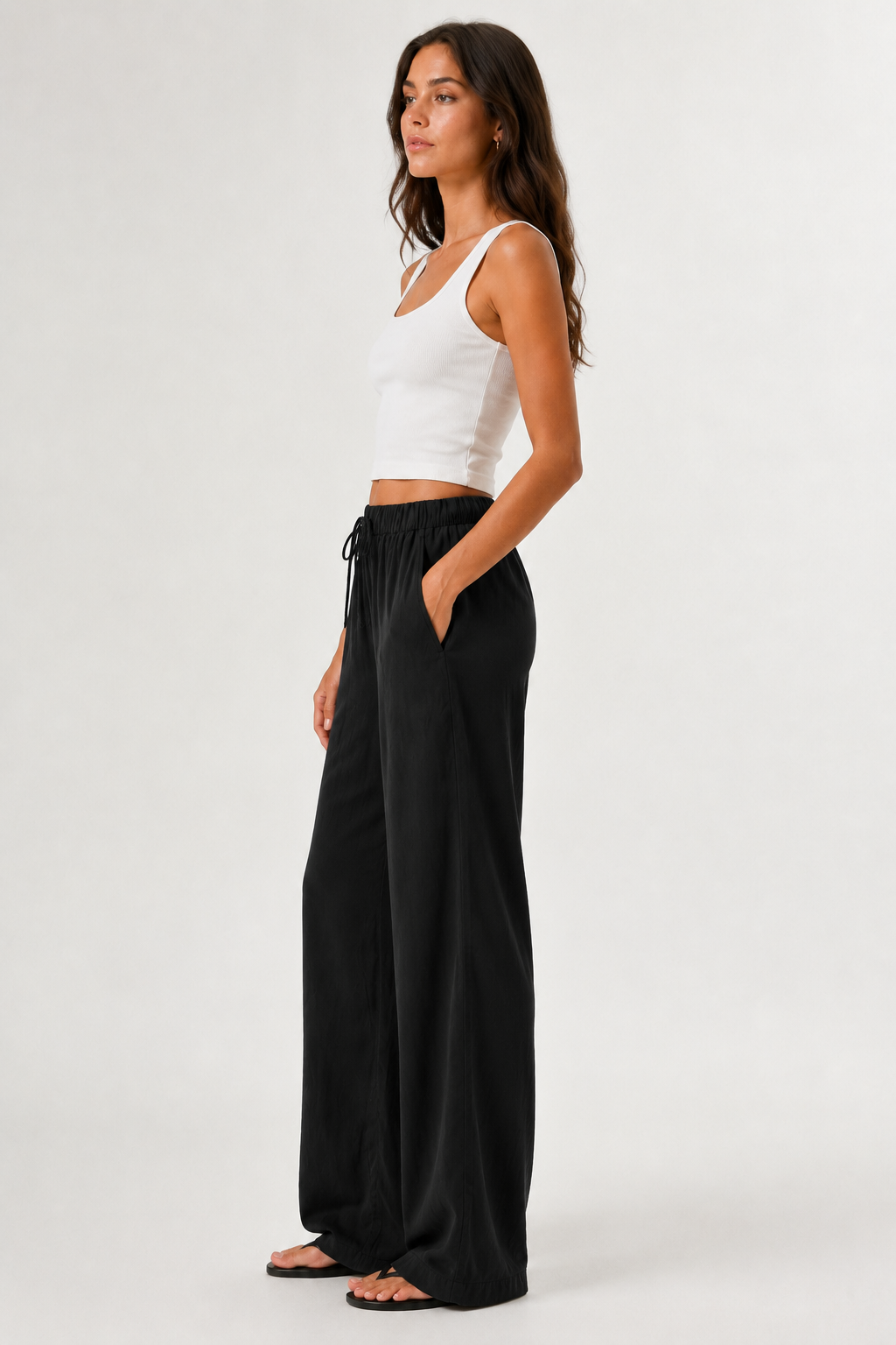 Woman modeling premium high-waisted wide-leg pants in black Onyx against a clean studio background