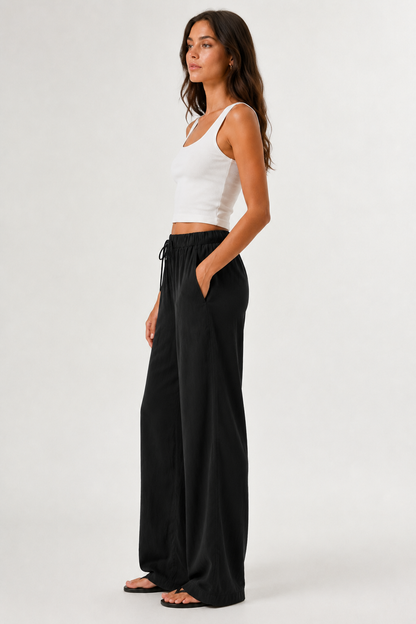 Woman modeling premium high-waisted wide-leg pants in black Onyx against a clean studio background