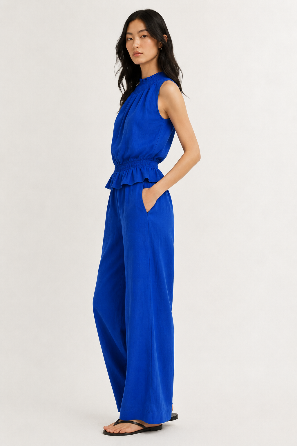 Woman wearing a premium minimalist lapis blue two piece set with sleeveless top and wide leg pants