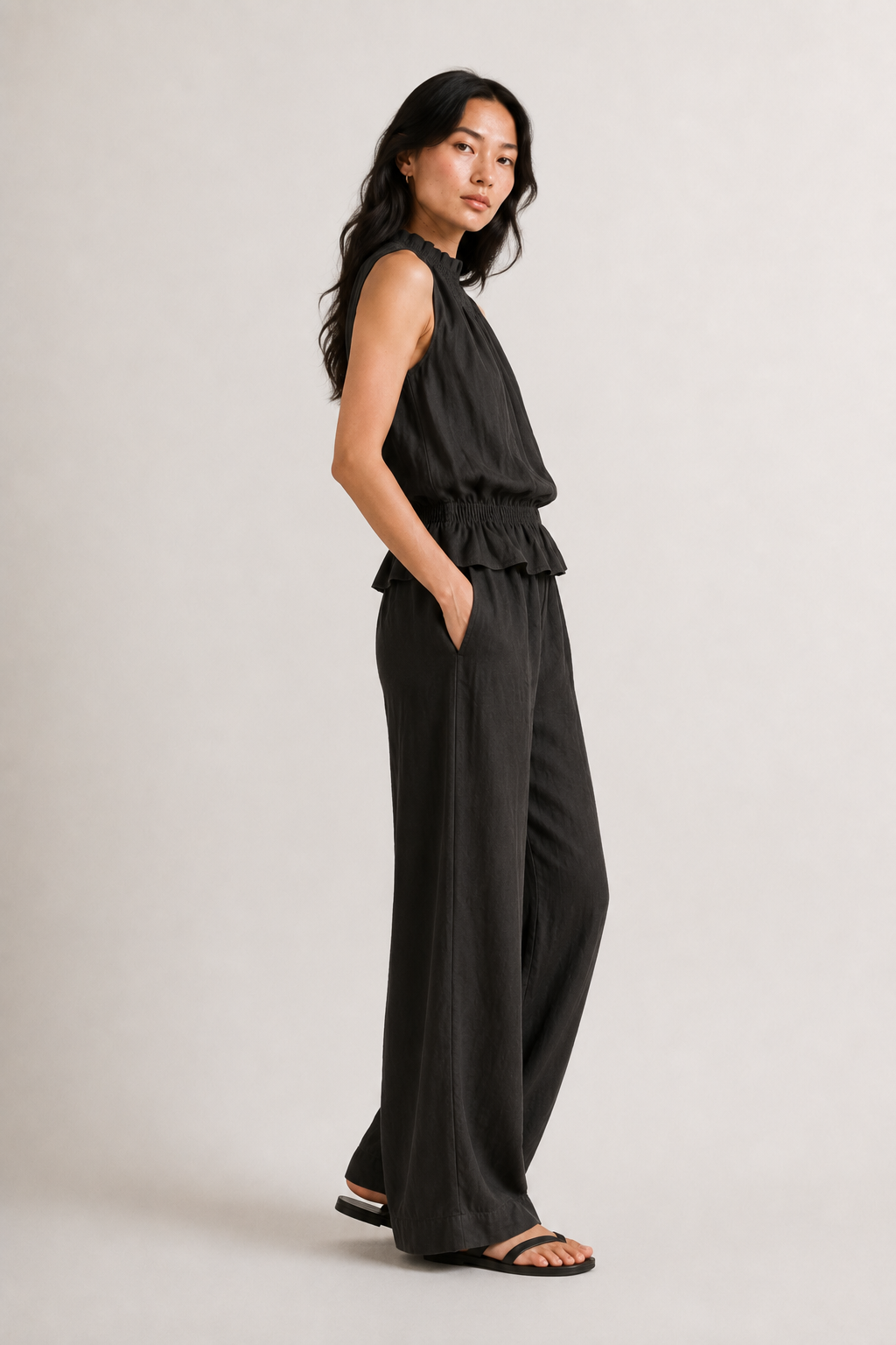 Woman wearing a premium minimalist washed onyx black two piece set with sleeveless top and wide leg pants