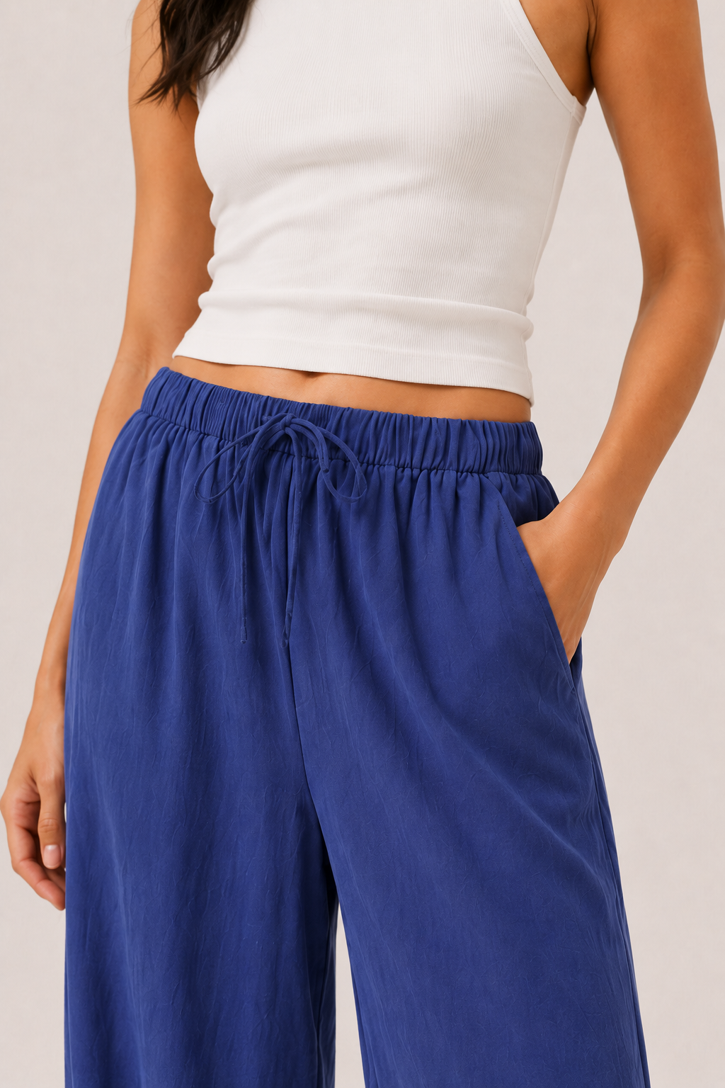 Woman modeling premium high-waisted wide-leg pants in bright blue Cobalt against a clean studio background