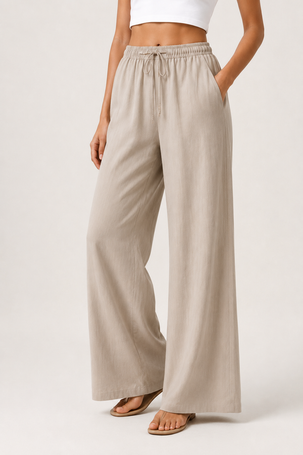 Woman modeling premium high-waisted wide-leg pants in light beige Light Birch against a clean studio background