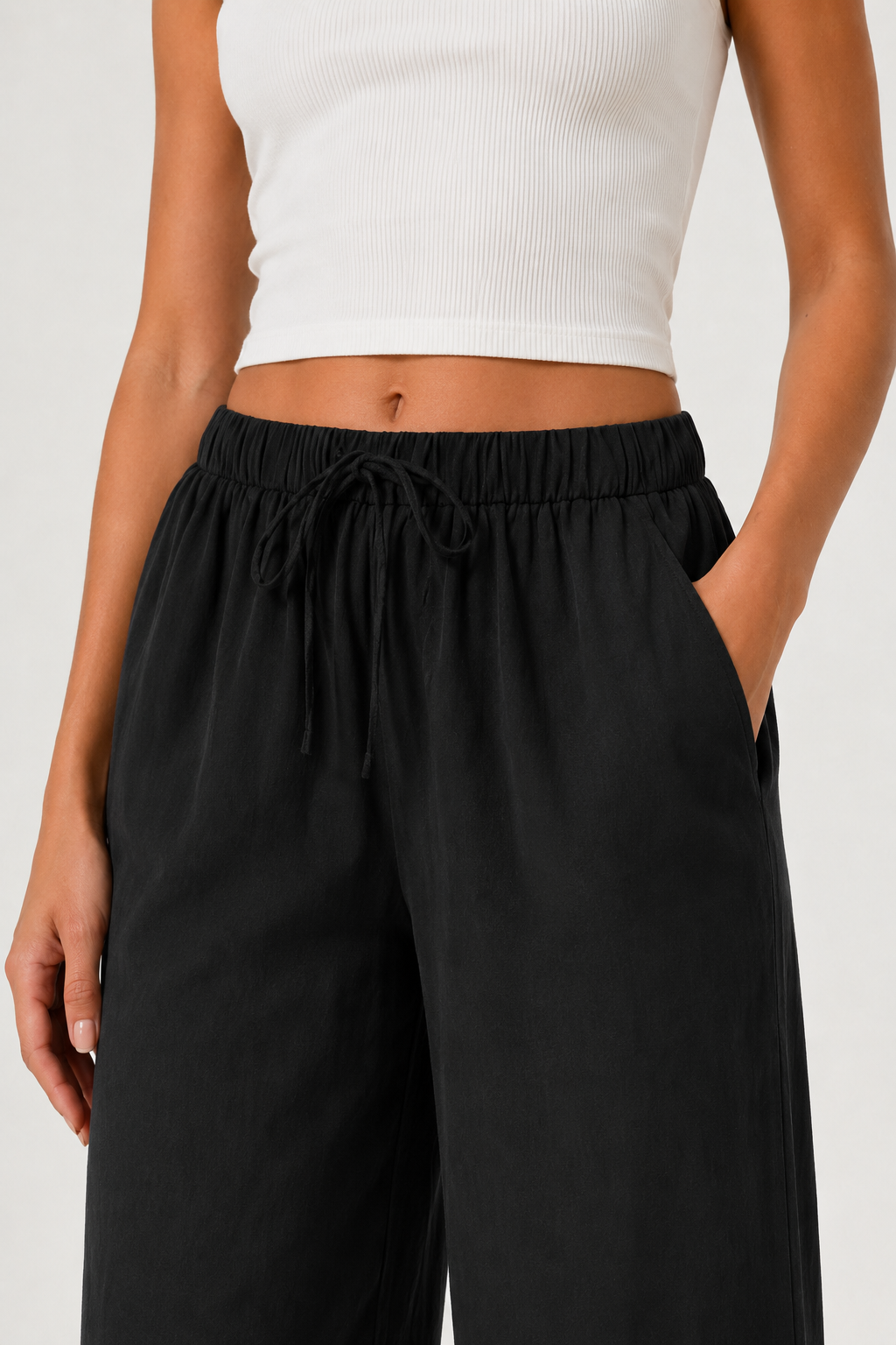 Woman modeling premium high-waisted wide-leg pants in black Onyx against a clean studio background