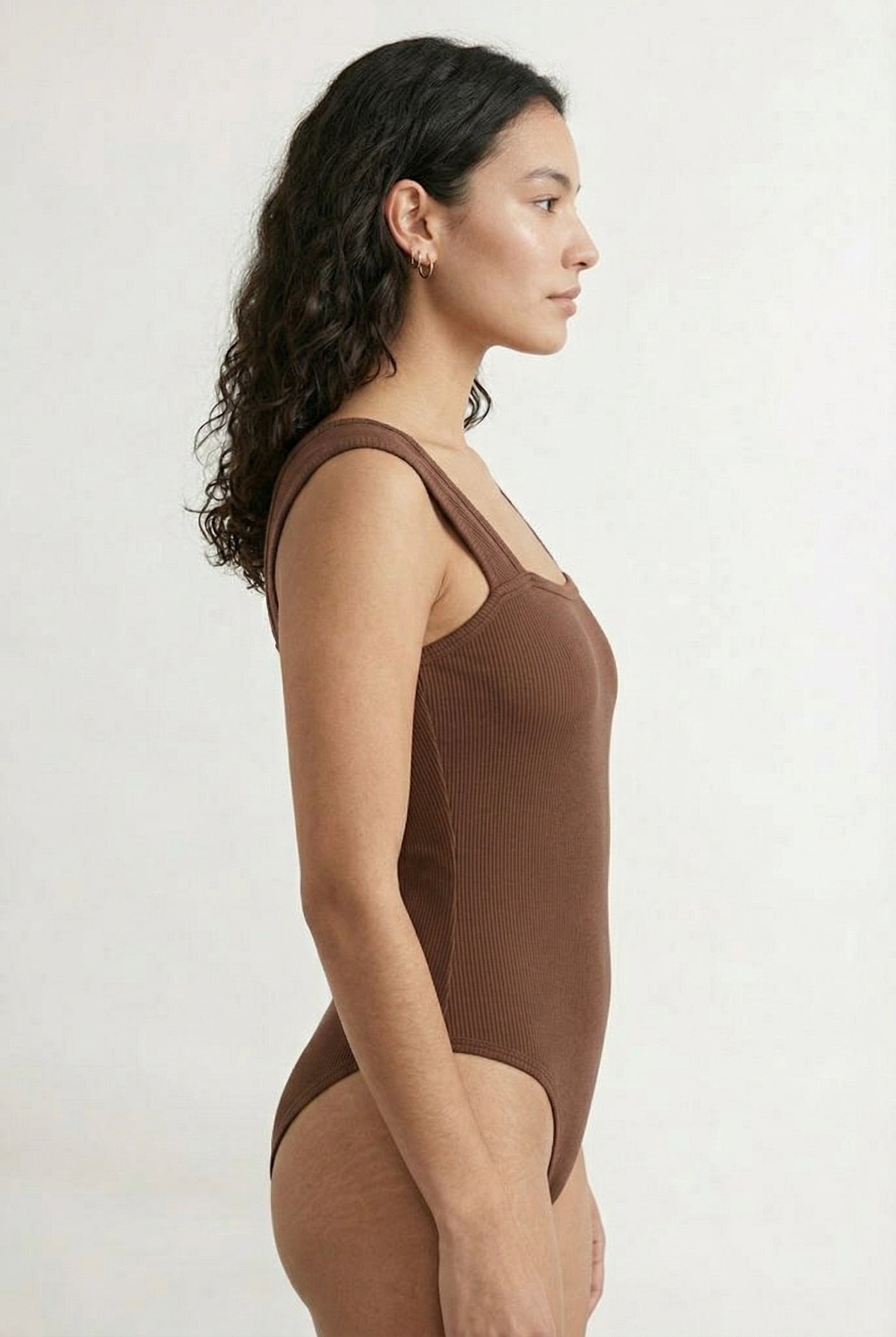 Model wearing a Rich Mocha brown square neck one-piece swimsuit