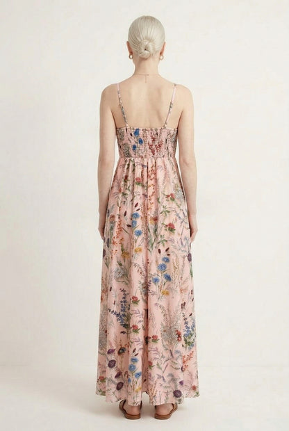 Woman wearing a rosewater pink floral print maxi dress with spaghetti straps