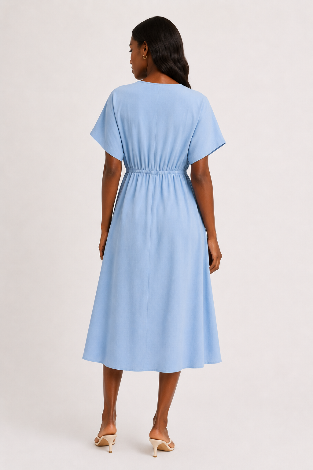 Full body studio image of a model in the ashen blue Sabine midi with short sleeves.