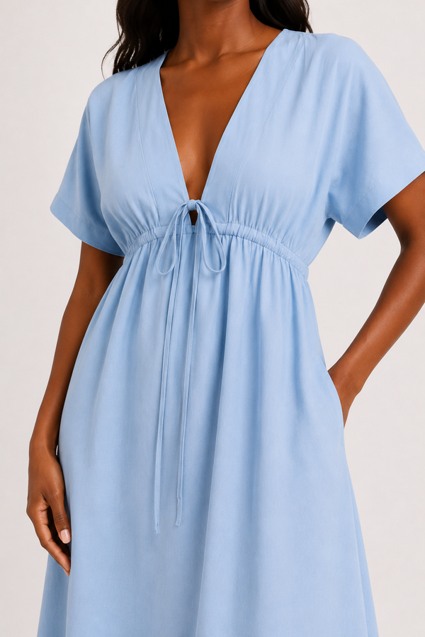 Full body studio image of a model in the ashen blue Sabine midi with short sleeves.