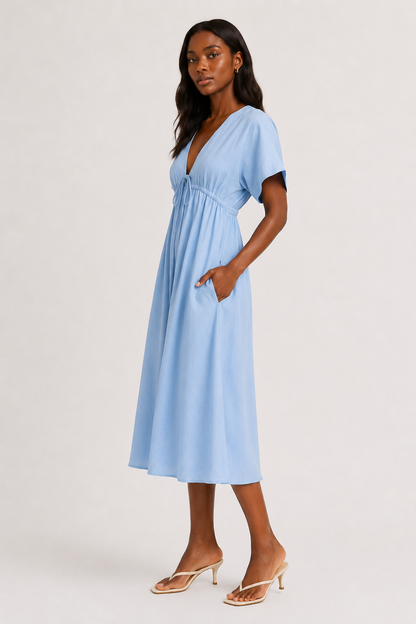 Full body studio image of a model in the ashen blue Sabine midi with short sleeves.