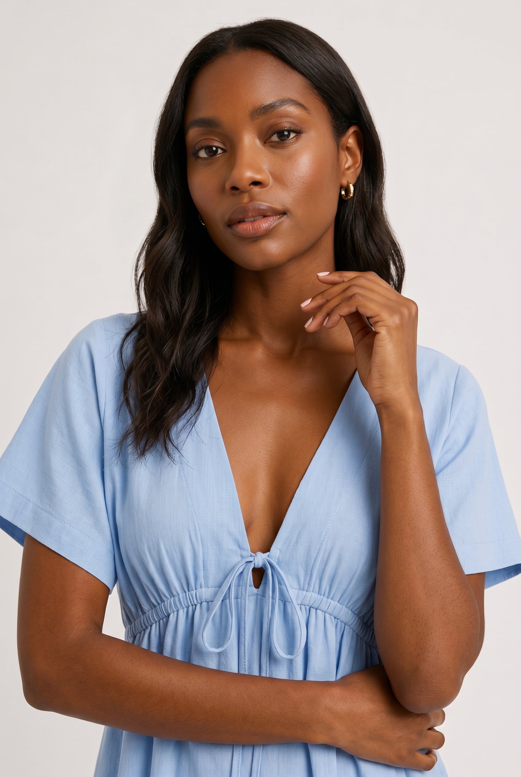 Full body studio image of a model in the ashen blue Sabine midi with short sleeves.