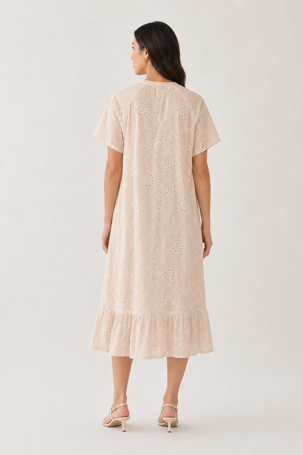 Woman modeling a short-sleeve v-neck midi dress in light beige Dune