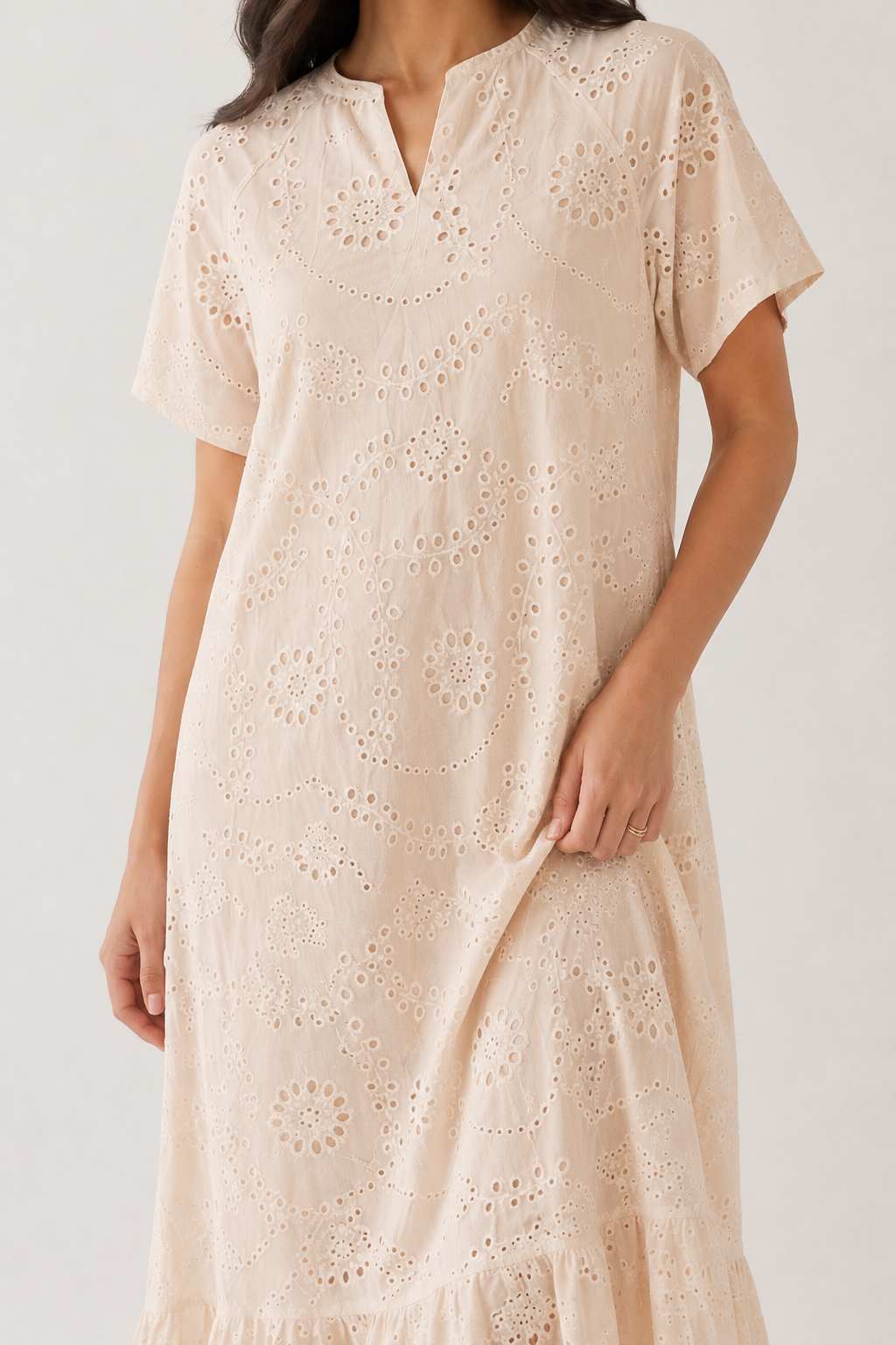 Woman modeling a short-sleeve v-neck midi dress in light beige Dune