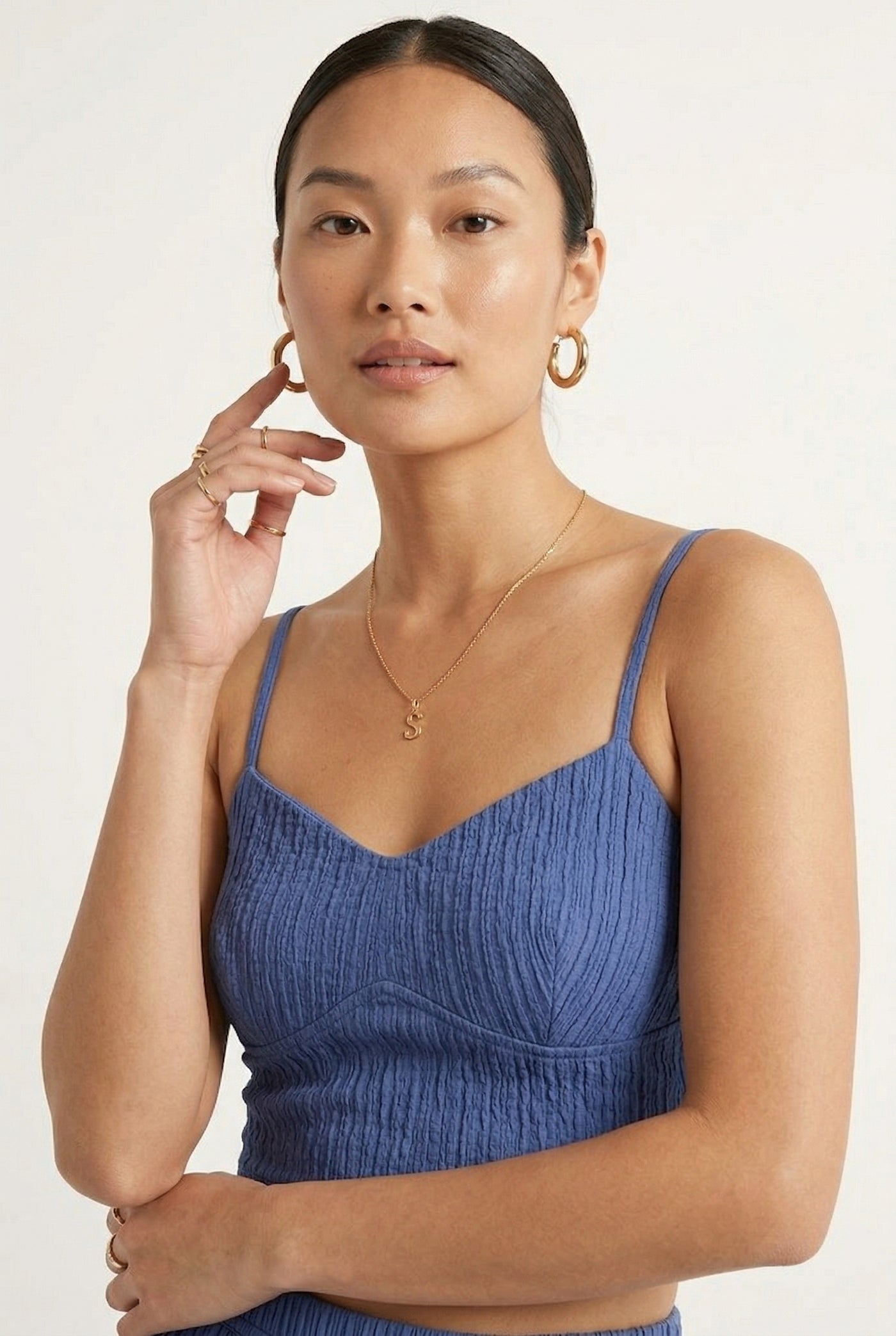 Woman modeling a Slate Blue two-piece matching set featuring a spaghetti strap crop top and tiered maxi skirt