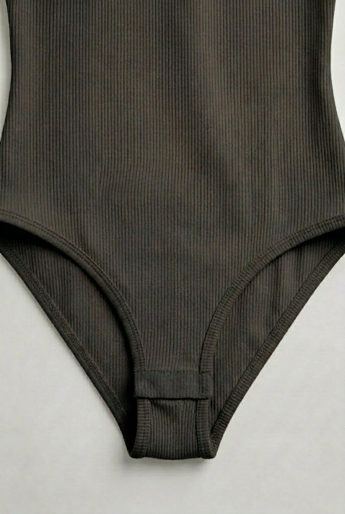 Model wearing a Smoked Onyx black square neck one-piece swimsuit