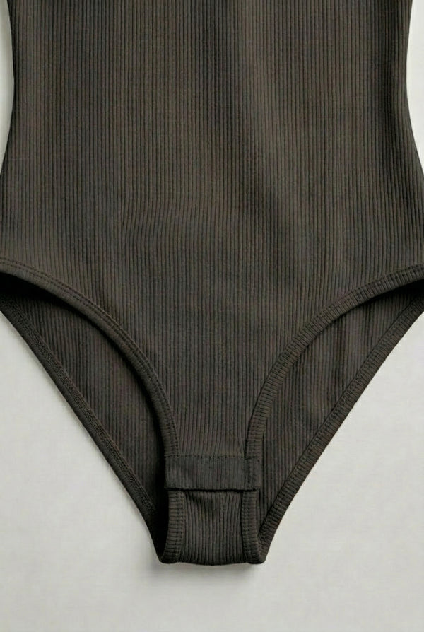 Model wearing a Smoked Onyx black square neck one-piece swimsuit