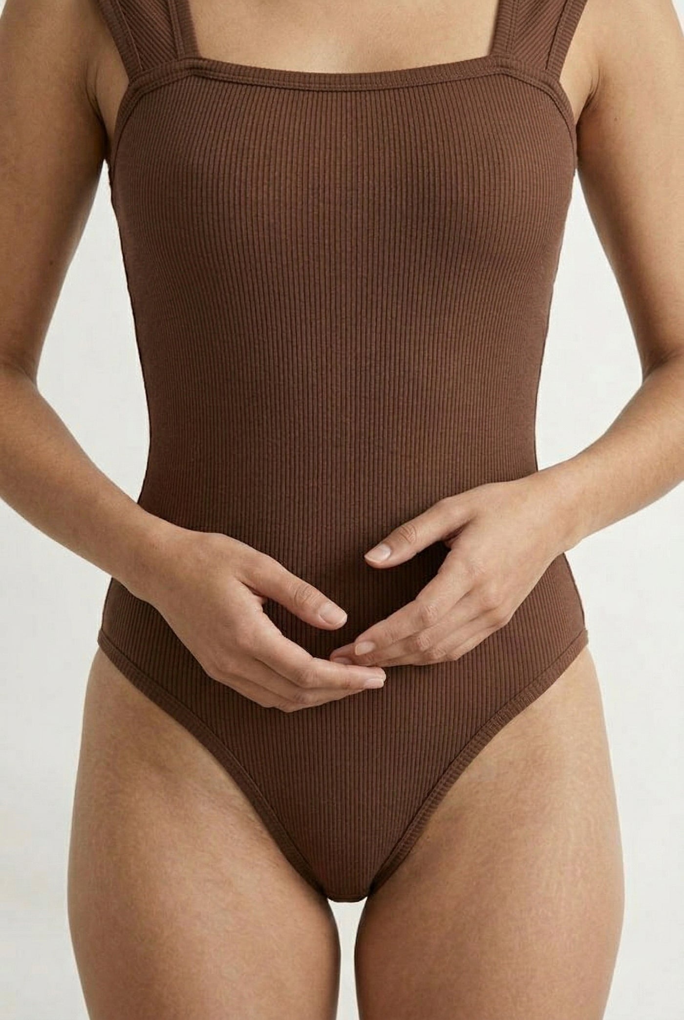 Model wearing a Rich Mocha brown square neck one-piece swimsuit