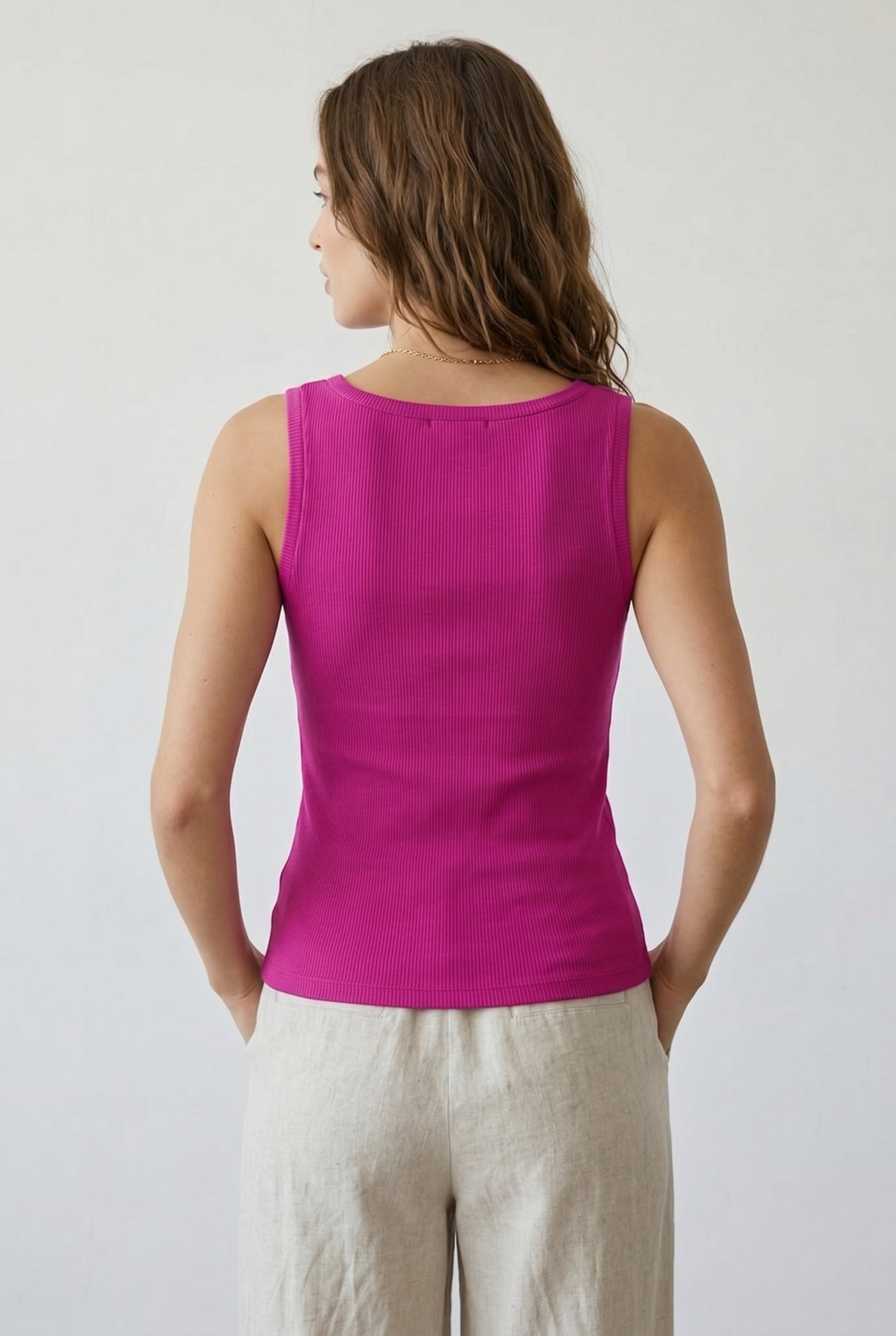 Woman wearing the Staple Scoop Tank in bright pink Dragonfruit