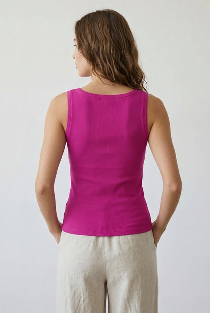 Woman wearing the Staple Scoop Tank in bright pink Dragonfruit