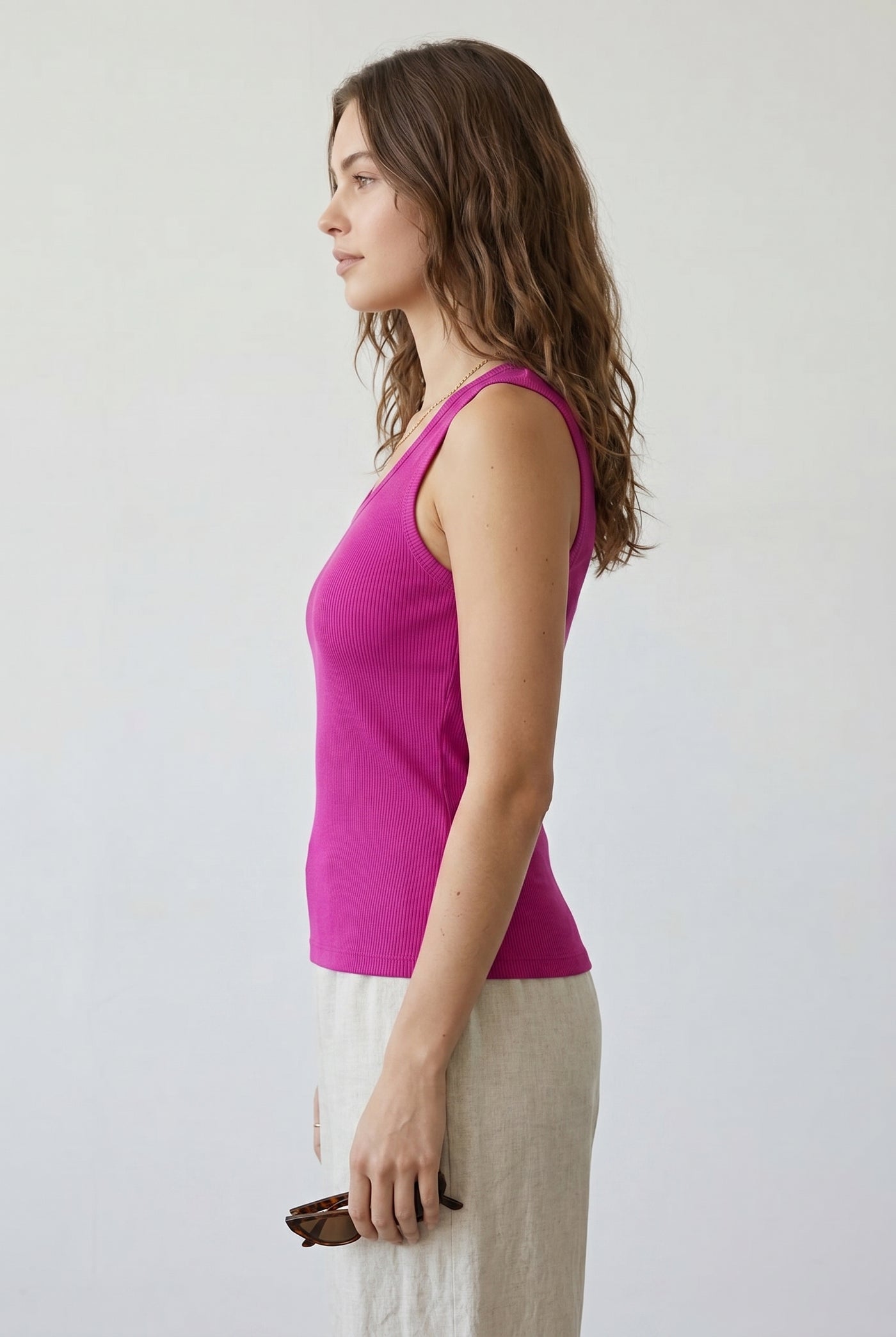 Woman wearing the Staple Scoop Tank in bright pink Dragonfruit