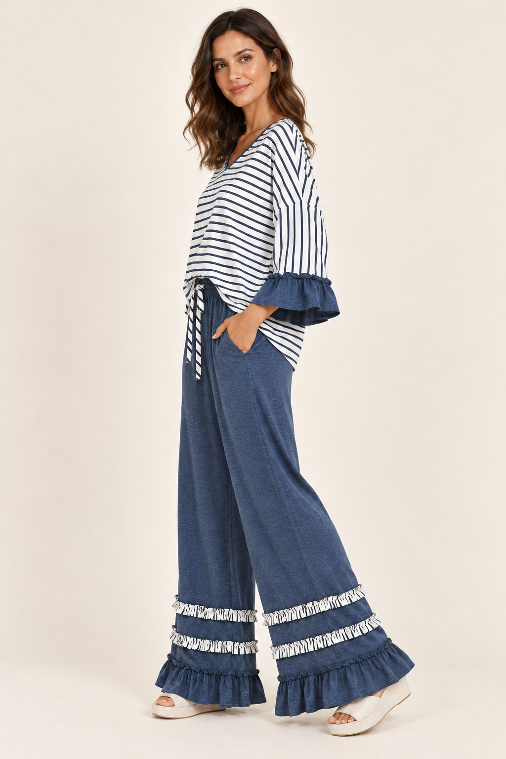 Three-quarter view of the Tess Striped Ruffle Set in Blue, showing the wide-leg pants and ruffled cuffs.