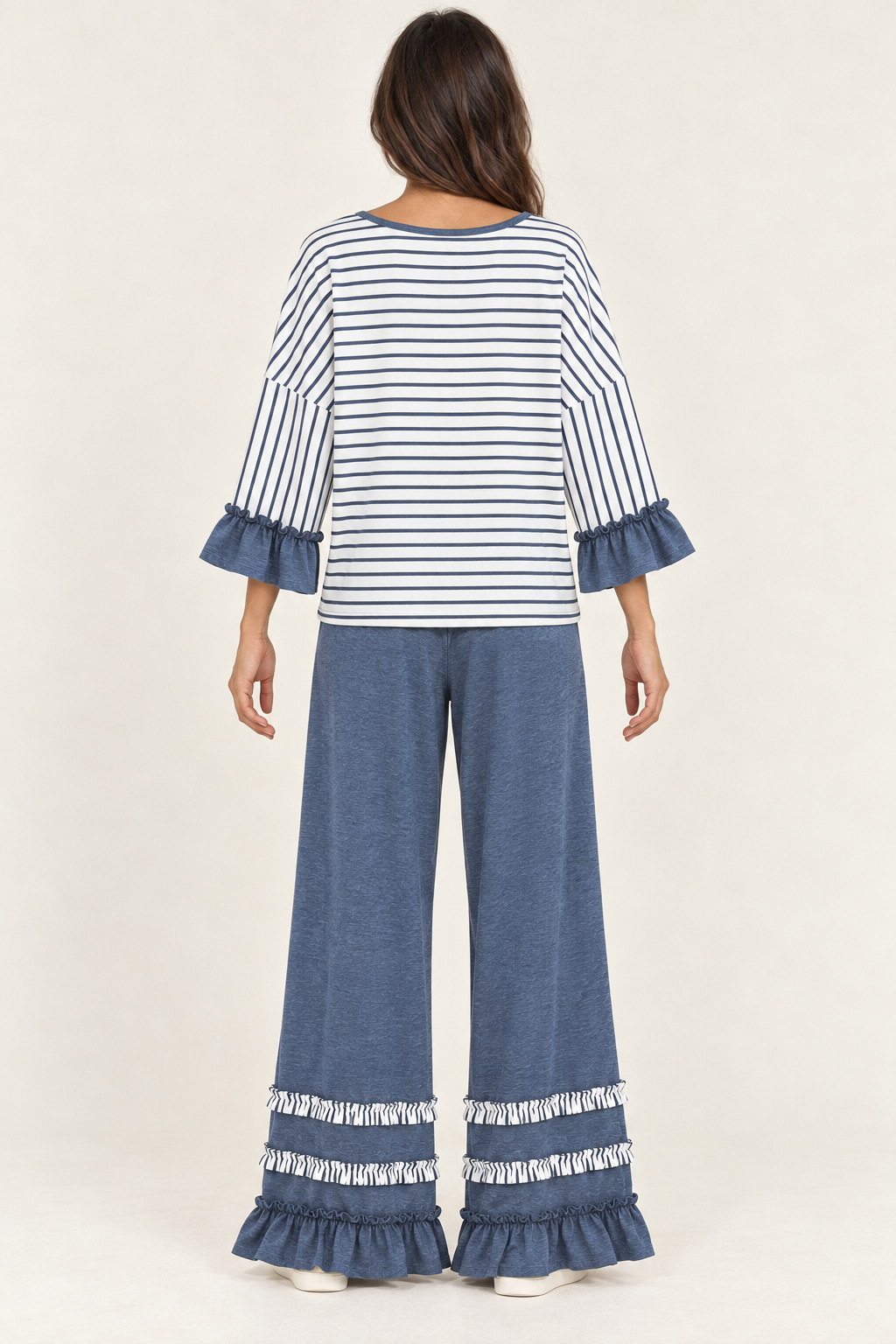 Back view of the Tess Striped Ruffle Set in Blue, with round back neckline and ruffled pant hems.