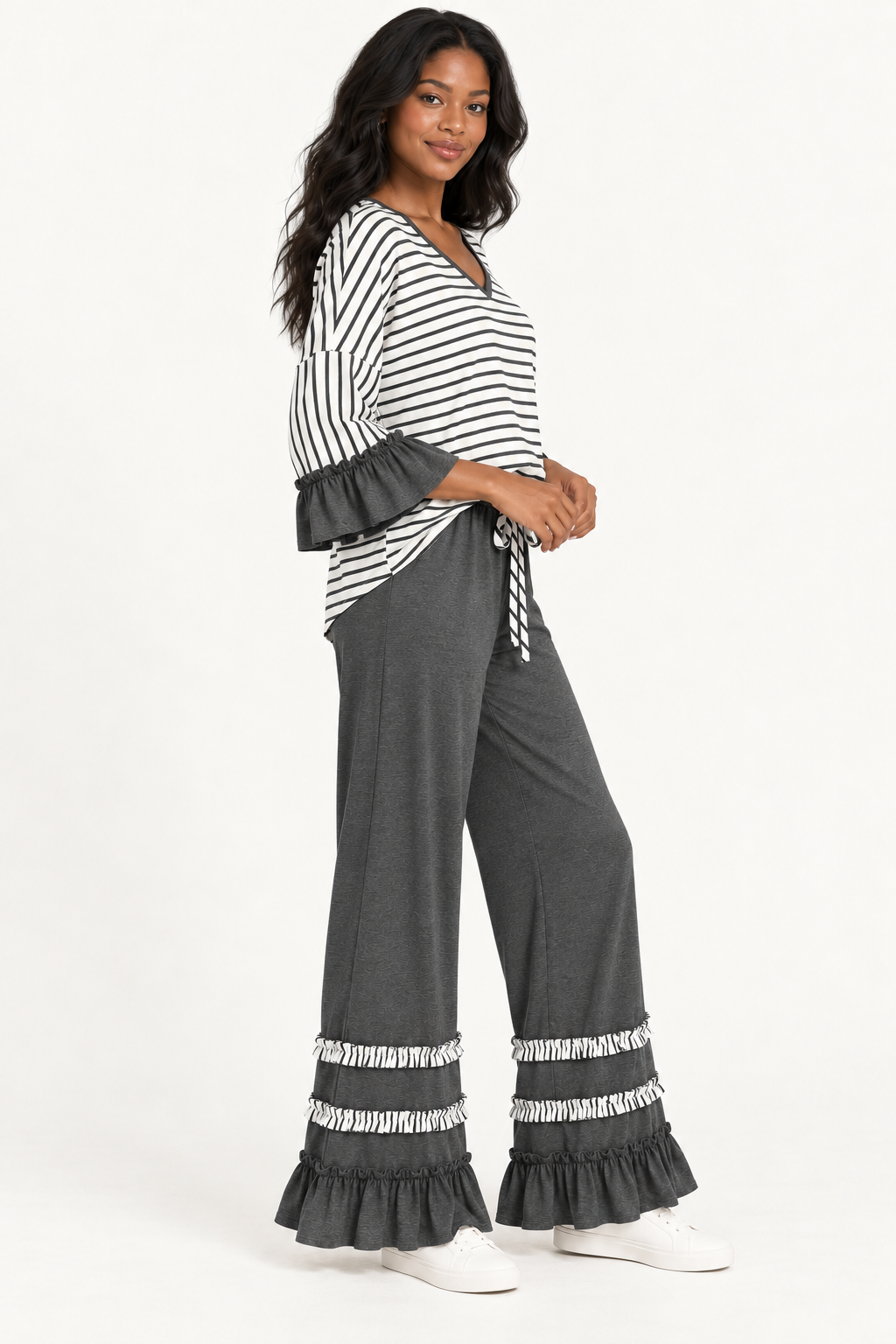Three-quarter view of the Tess Striped Ruffle Set in Charcoal, showing the wide-leg pants and ruffled cuffs.