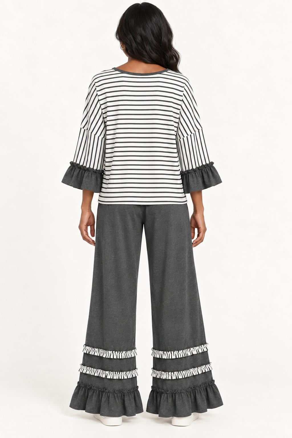 Back view of the Tess Striped Ruffle Set in Charcoal, with round back neckline and ruffled pant hems.