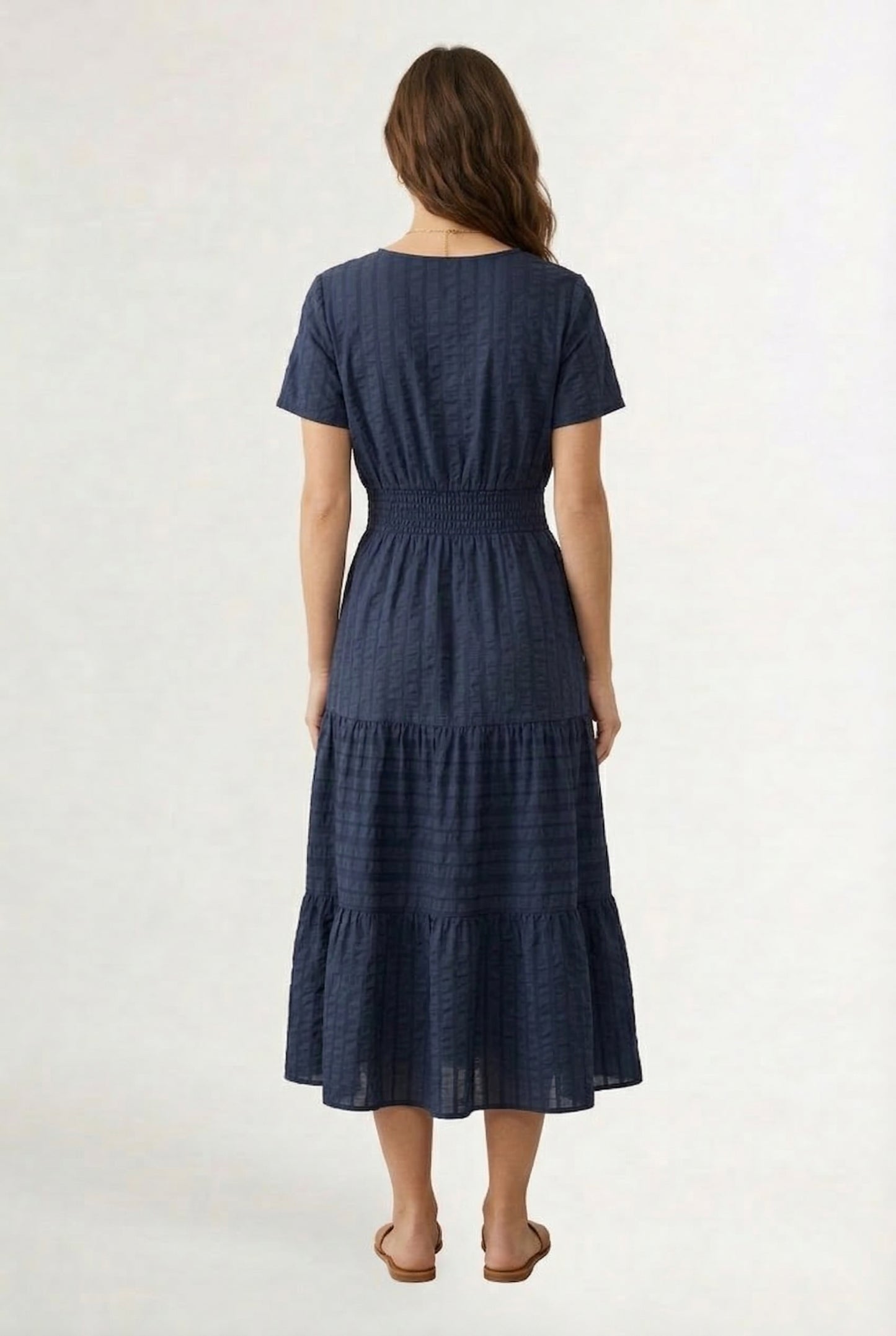 A woman wearing a dark navy Total Eclipse short-sleeve midi dress with a button-down front.