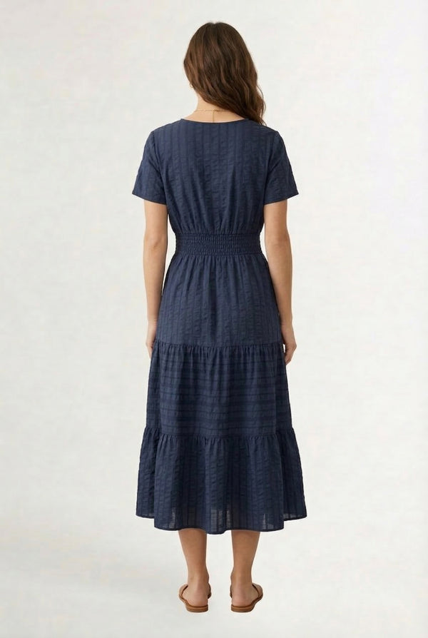A woman wearing a dark navy Total Eclipse short-sleeve midi dress with a button-down front.